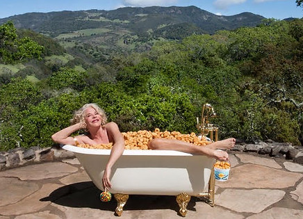 Trish inside a tub of donuts